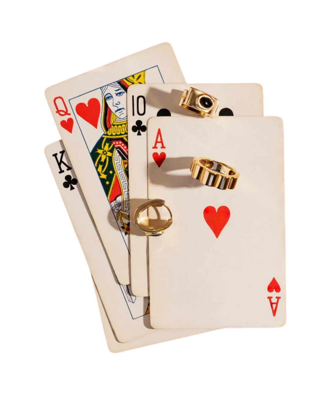 Playing cards fanned out with gold rings resting on top